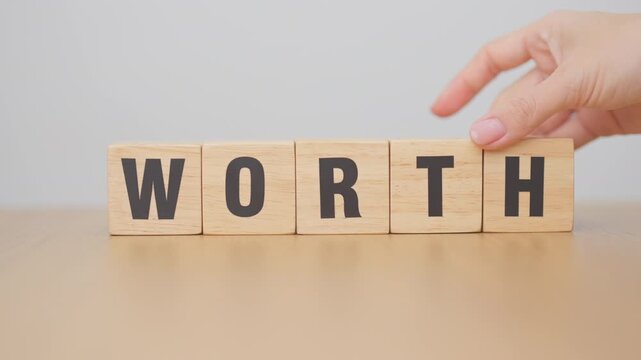 hand change wooden block Work to Worth. Know your worth concept