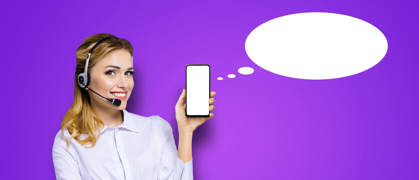 Customer support callcenter phone operator blond woman, headset hold show point smartphone cell phone mobile blank mockup screen, isolated purple background. Call center. Empty mock up speech bubble