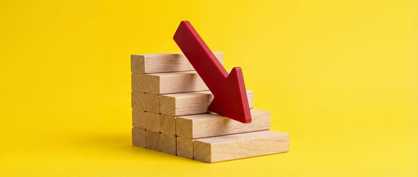 Business Decline Concept with Red Arrow and Wooden Stair Blocks on Yellow Background