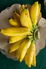 Fresh bunches of ripe yellow bananas hanging in a local market © IMAZA Photo