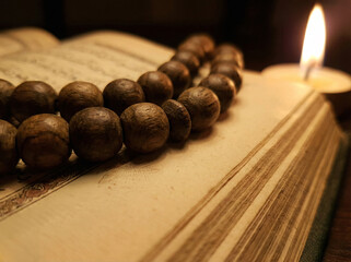 Traditional Ramadan Dates and Prayer Beads with Candle Light on Wooden Surface Iftar Food