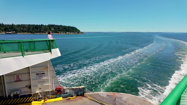 Wake of cruise ship. Boat creates foam on water surface. Back view of wide wake trail from boat. Deep blue color. Travel and journey concept.