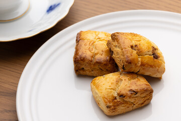 Freshly Baked Scones on White Plate with Teacup
