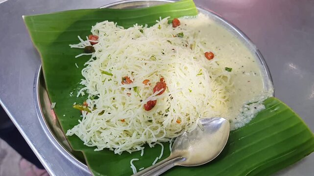 A closeup of delicious vermicelli lemon rice with coconut chutney served on a banana leaf