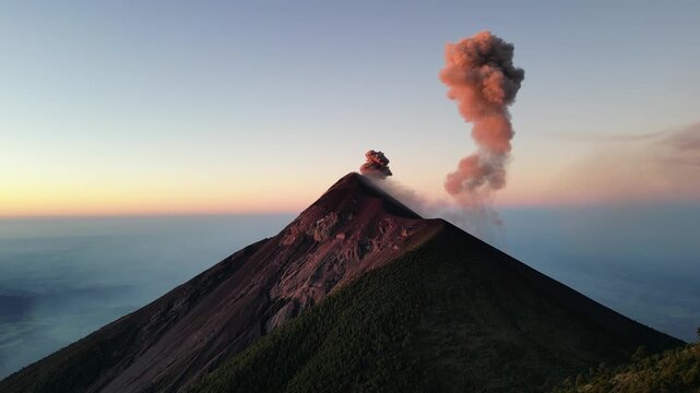 large volcano acatenango erupting in guatemala highlands (famous volcanic hike tourist destination fuego lava smoke) sunrise hiking daybreak geology stunning adventure travel camping antigua getaway