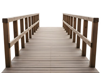 A long, centered view of a wooden boardwalk footbridge with railings isolated against a pure black background