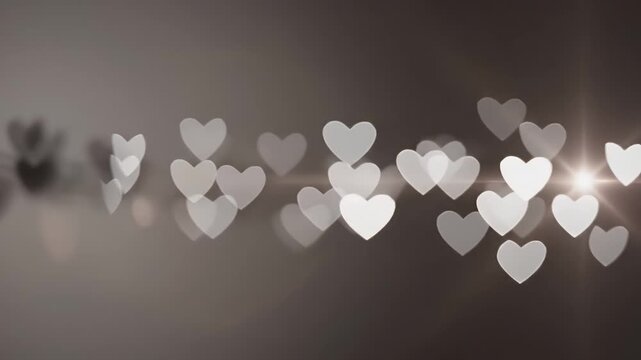 Shimmering heart-shaped bokeh lights create a romantic and festive background, casting a soft glow against a dark, abstract setting, perfect for love-themed celebrations and warm sentiments