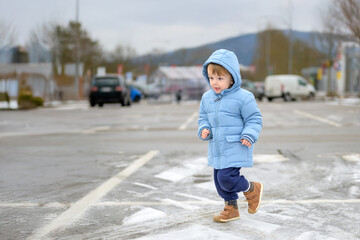 Fototapeta premium Toddler Running On Icy Parking