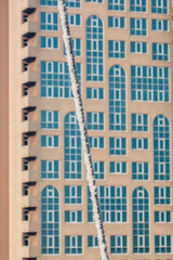 Fototapeta premium A wire frozen by snow and ice against a backdrop of a multi-story building