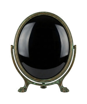 Antique black scrying mirror isolated. Magic divination object.