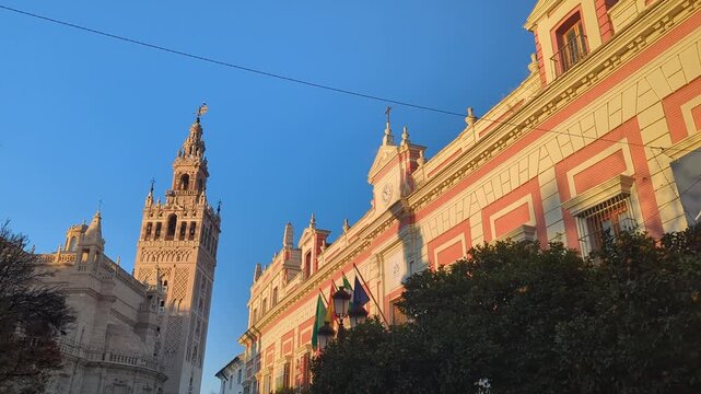 Seville Spain. The iconic Giralda tower stands tall against the blue sky. A stunning view of historic architecture. Experience the beauty of this cultural city.