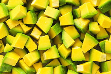 Full-frame view of diced avocado pieces, highlighting fresh texture and vibrant green color.