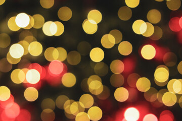 Fototapeta premium A yellow and red bokeh background featuring soft, glowing light orbs in warm tones. The out-of-focus circles create a luminous and celebratory atmosphere.