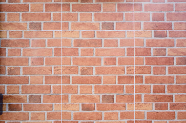 Fototapeta premium A clean, evenly laid red brick wall that serves as a versatile background for branding, photography backdrops, and architectural studies. Textured, warm, and timeless with an urban feel.