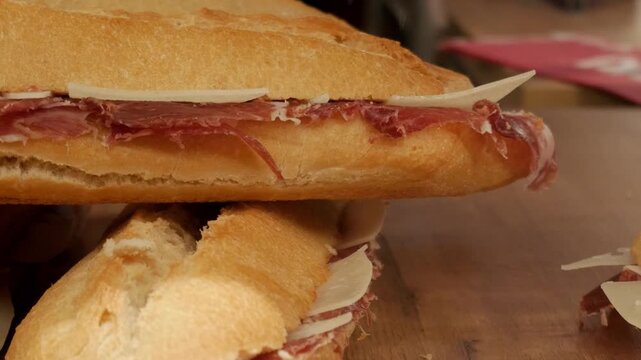 Jamon y queso sandwich with jamon serrano on a wooden table