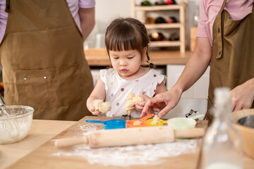 Close up of parents lovingly care for and raises baby girl at home. 