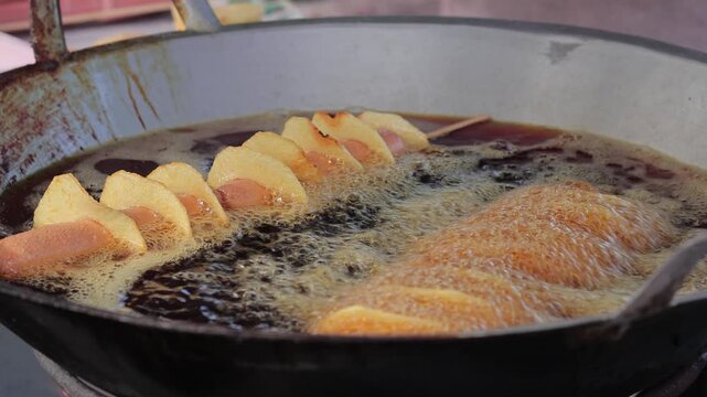 Indonesian street food jajanan frying in hot bubbling oil with natural light for culinary concept