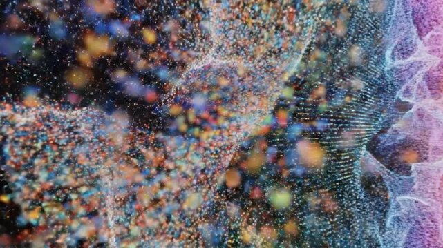 A vibrant, multi-colored cloud of particles forms a spherical shape on a black backdrop