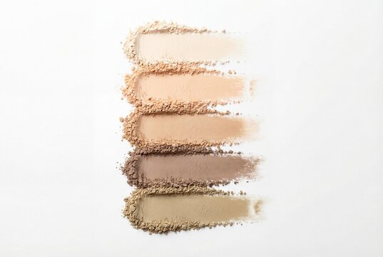 Cosmetic loose powder swatches in neutral tones arranged vertically