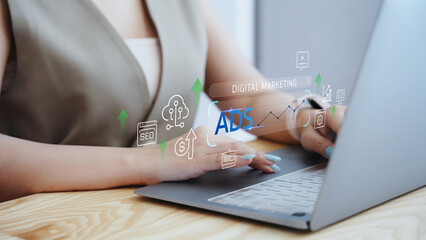 Businesswoman using laptop with virtual digital marketing and ADS dashboard. Concept of online advertising strategy, SEO analytics, social media growth, and business technology.