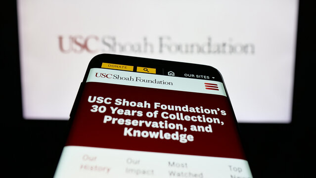 Stuttgart, Germany - 01-30-2026: Mobile phone with website of US organisation USC Shoah Foundation on screen in front of logo. Focus on top-left of phone display.