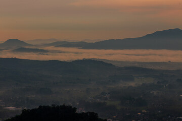 Obraz premium The backdrop of the landscape features large, naturally formed rock mountains with unique and beautiful shapes, nestled amidst pine trees in a tropical climate, reflecting the balance of the ecosystem