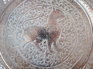 Intricate Silver Engraving of a Mythical Beast