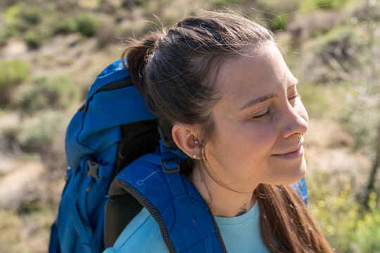 Woman hiking enjoying sunlight and fresh air outdoors