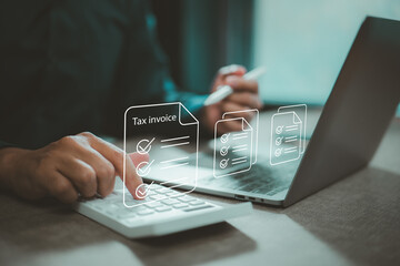Calculating tax invoice and accounting with laptop and calculator in modern office