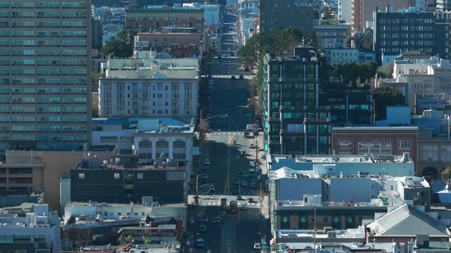 Telephoto descending aerial shot of California Street towards the Tenderloin on Nob Hill in San Francisco, California. 4K