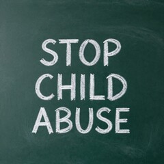 Fototapeta premium Stop child abuse message written on chalkboard in white chalk for awareness campaign