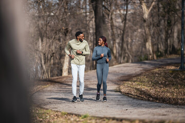 Obraz premium African american couple running together in park