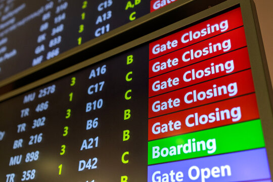 Close-up view of an airport departure information board displaying flight boarding status, gate opening, gate closing, and last call notices at a Airport.