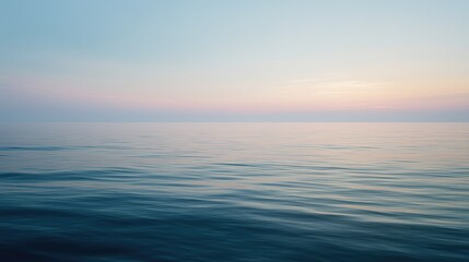 Obraz premium Calm ocean horizon background with soft pastel sky and minimal copy space.