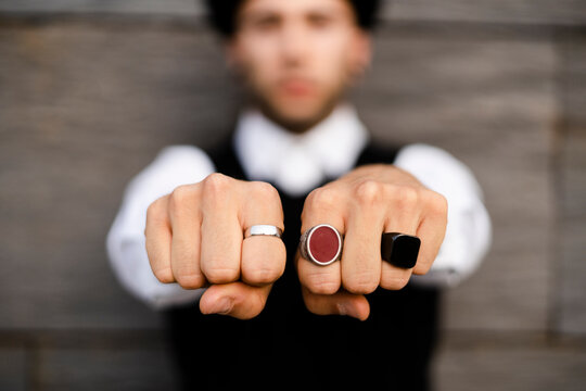 Man's hands with three various rings, close-up