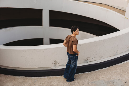 Young man walking up a parking garage.