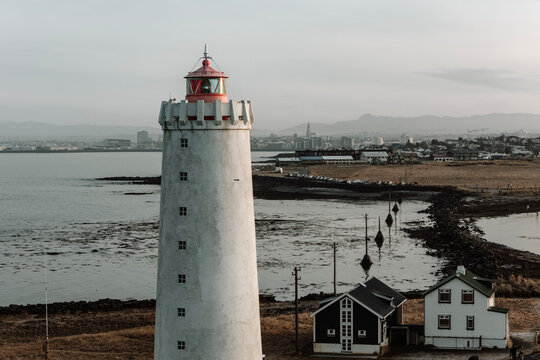 Lighthouse in iceland with city of Reykjavik in the background