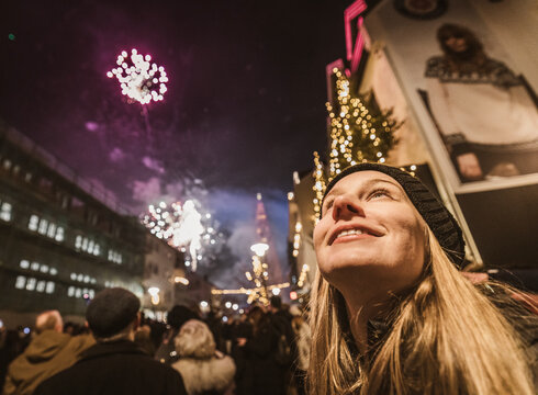 Woman marvels at New Years Eve fireworks, Reykjavik, Iceland