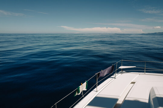 Men&rsquo;s Swim Shorts and Towel Hanging on Catamaran Rail over Oce