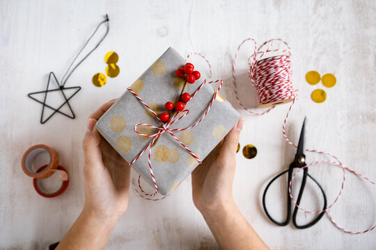Girl's hands holding wrapped Christmas present