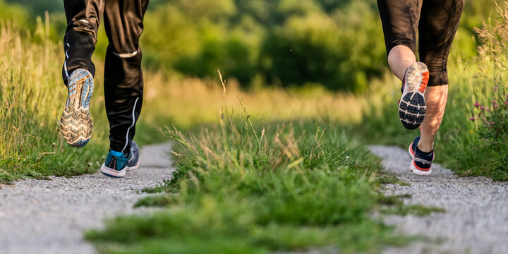 Legs of man and woman jogging