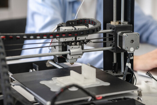 Student setting up 3D printer, close up