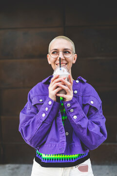 Young woman in the city enjoying a frappe