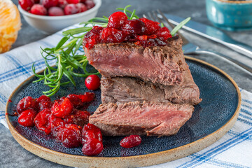Roasted ostrich loin with cranberry and orange sauce
