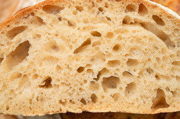 Close-up texture of homemade artisan sourdough bread. Macro photography of a slice of bread. Food...