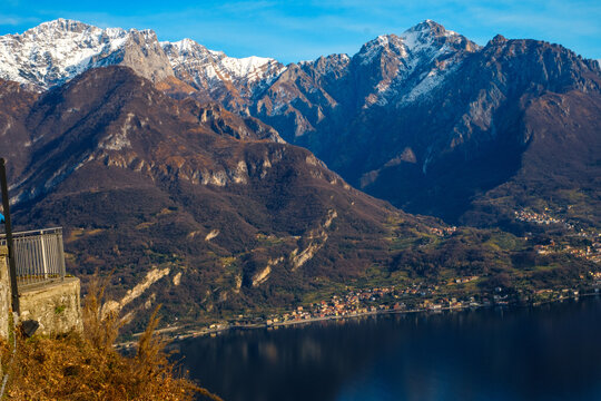 Panoramic view of Lake Como from Civenna overlooking Lecco, snow-capped Italian Alps, scenic Lombardy mountain landscape