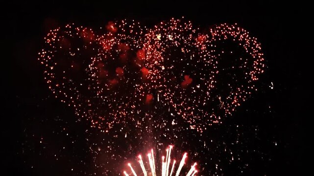 Red heart fireworks explosion on black background. Valentine's Day abstract animation.