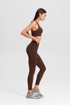 Athletic girl on the gray background. Fitness woman