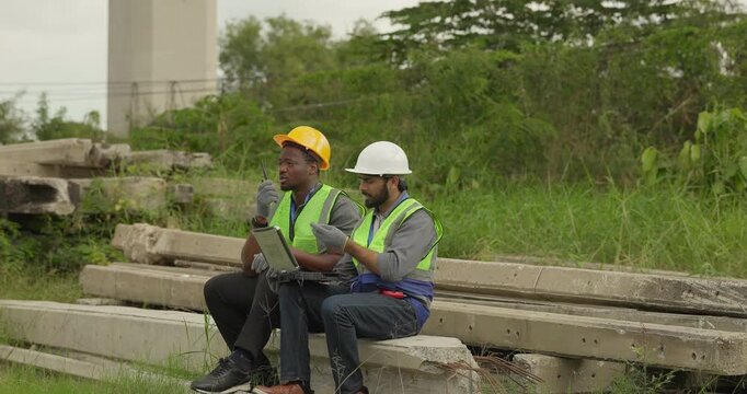 Railway engineer and technician conduct quality control material inspection on concrete pier segments and construction waste. Checking structural condition for safe site housekeeping and asset reuse.
