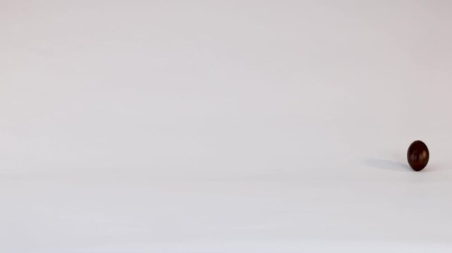 Miniature Chocolate American Football Bouncing on a Plain White Background